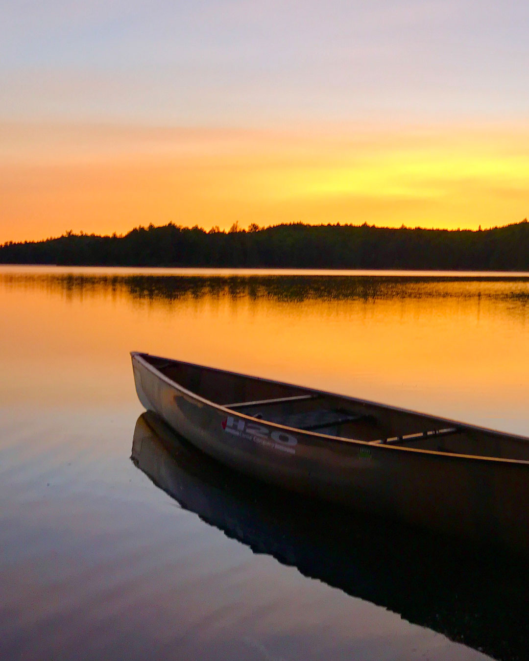 H2O Canoe Company Slideshow - Canoe on Water During Sunset